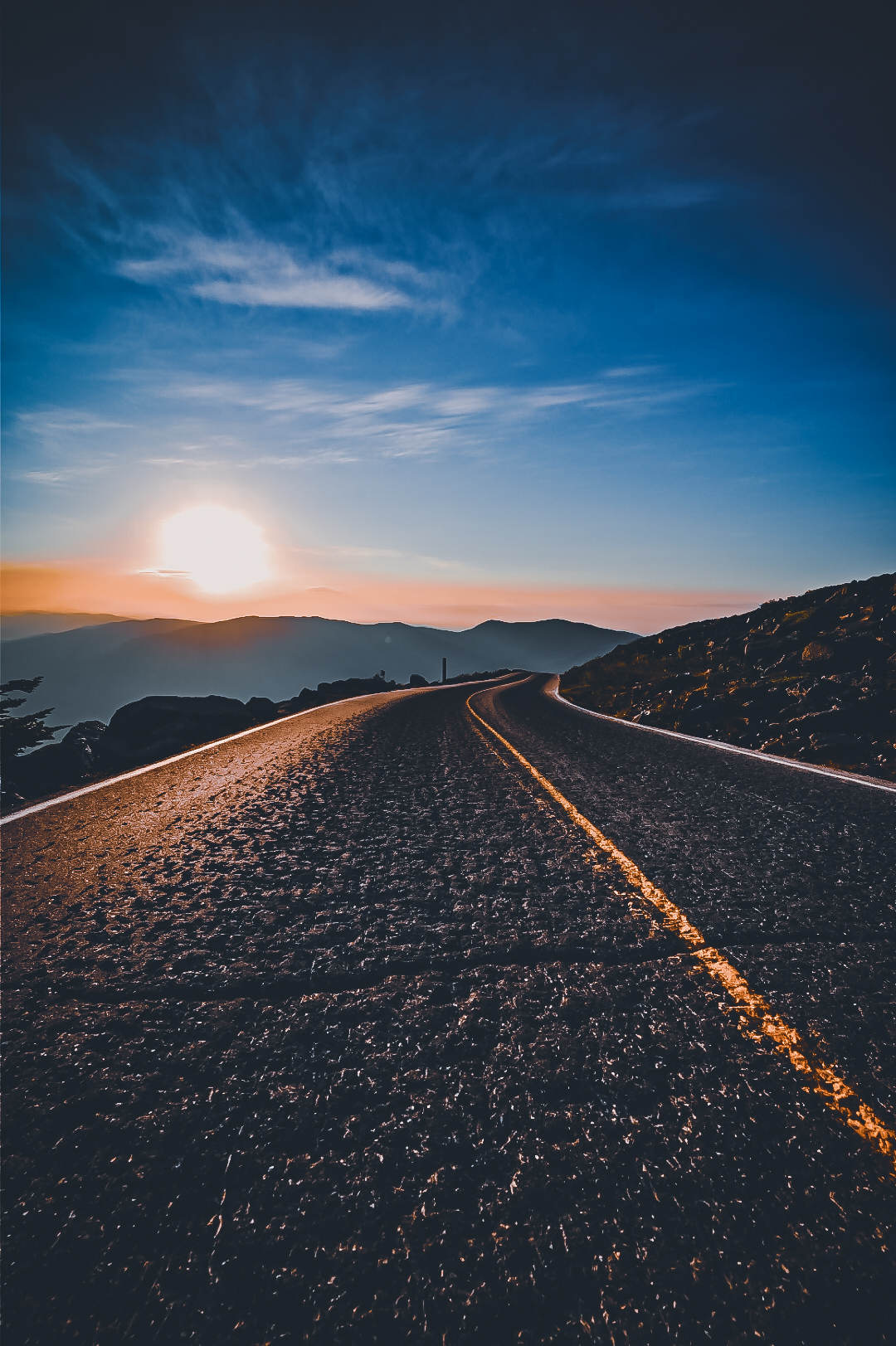 The Mount Washington Auto Road winding toward the sunset