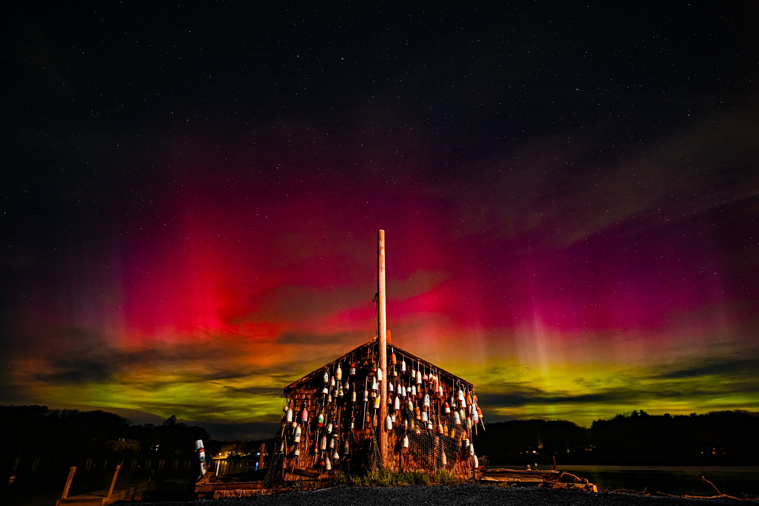 Aurora glowing green and pink over the York Lobster Pound in York, Maine